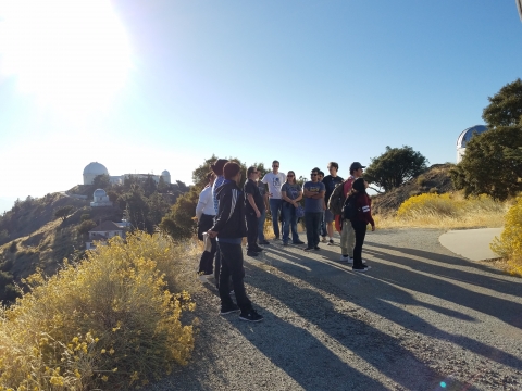 group with telescopes in background